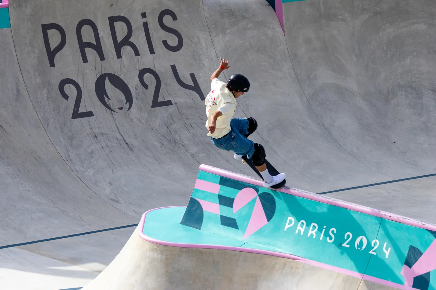 Skater carving the lip of the Paris 2024 bowl at Place de la Concorde.